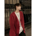 Men's solid colour V-neck knitted cardigan sweater in a loose fit on a hanger.