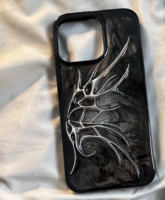 Black iPhone case with three-dimensional blurred wings design showing raised edges and precise port cutouts
