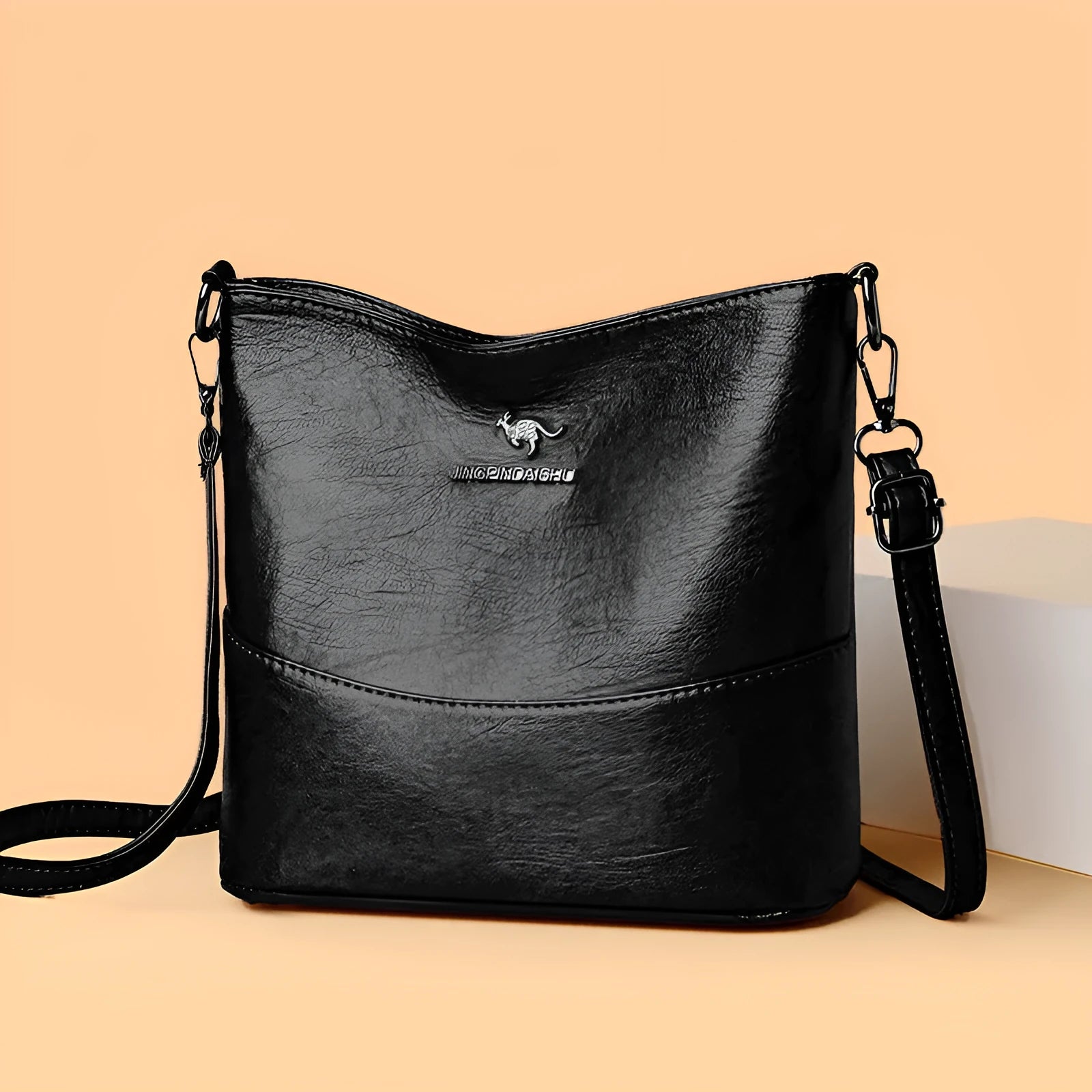 Women's soft leather bucket shoulder bag in black with sewing line detailing and mobile phone pocket