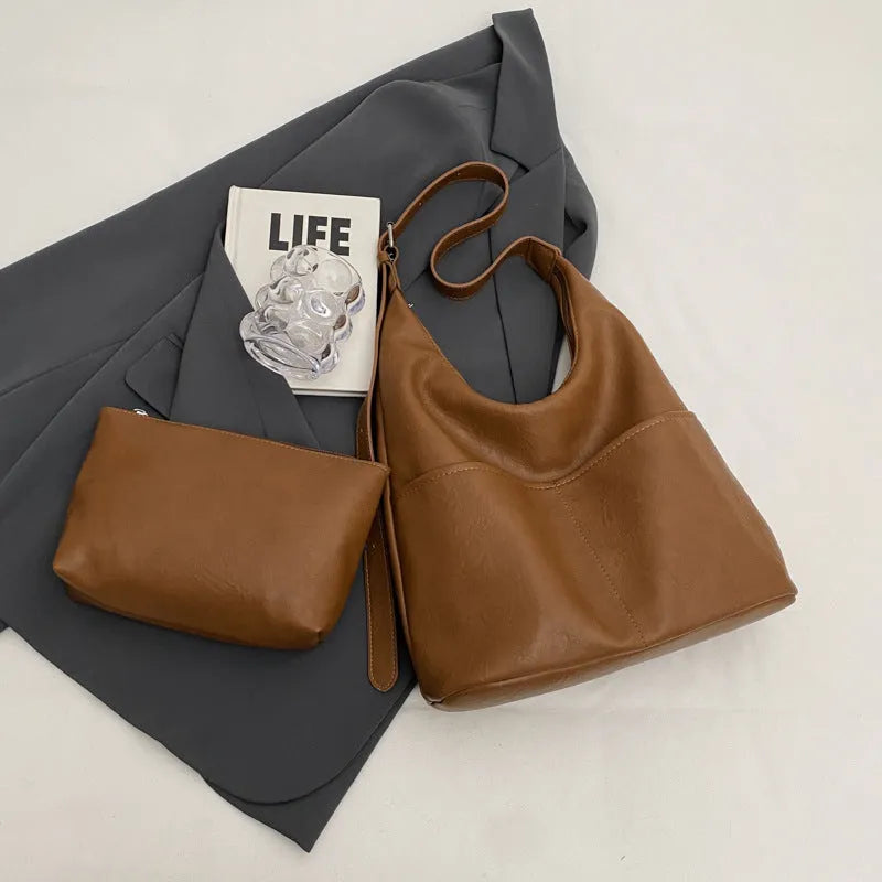 Women's large-capacity shoulder bag in soft PVC with bucket shape and stitching detail, available in black, coffee, brown, mud, beige