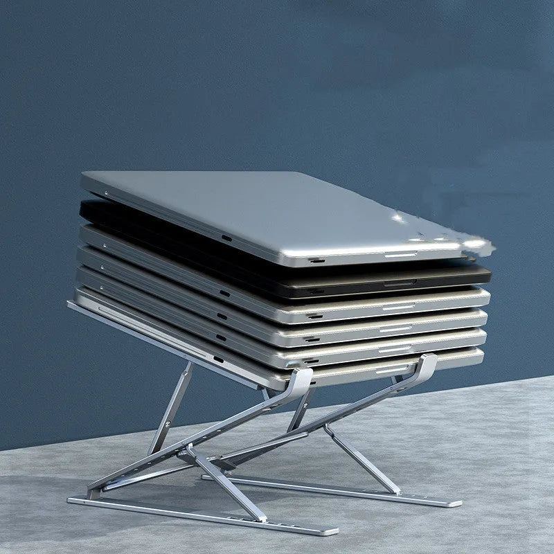 Folding aluminium computer stand bracket in grey with silicone pads on desktop surface