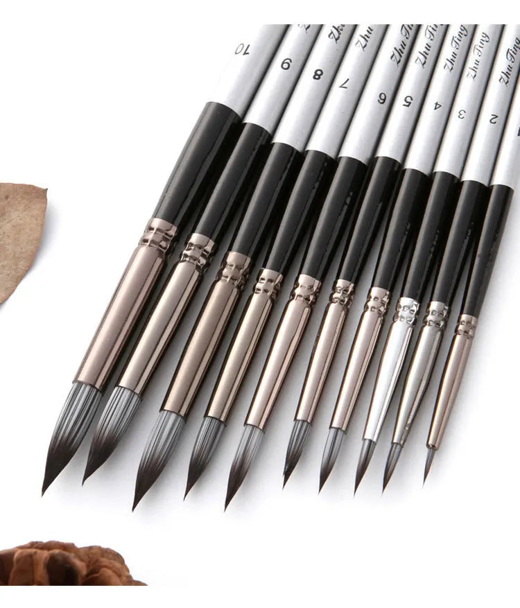 Ten black stick nylon paintbrushes with round tips, silver gray rods, and wood handles laid out
