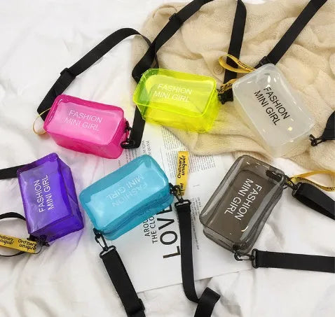 A transparent square jelly cross-body bag in a choice of colours, shown with an adjustable strap and a mobile phone inside.