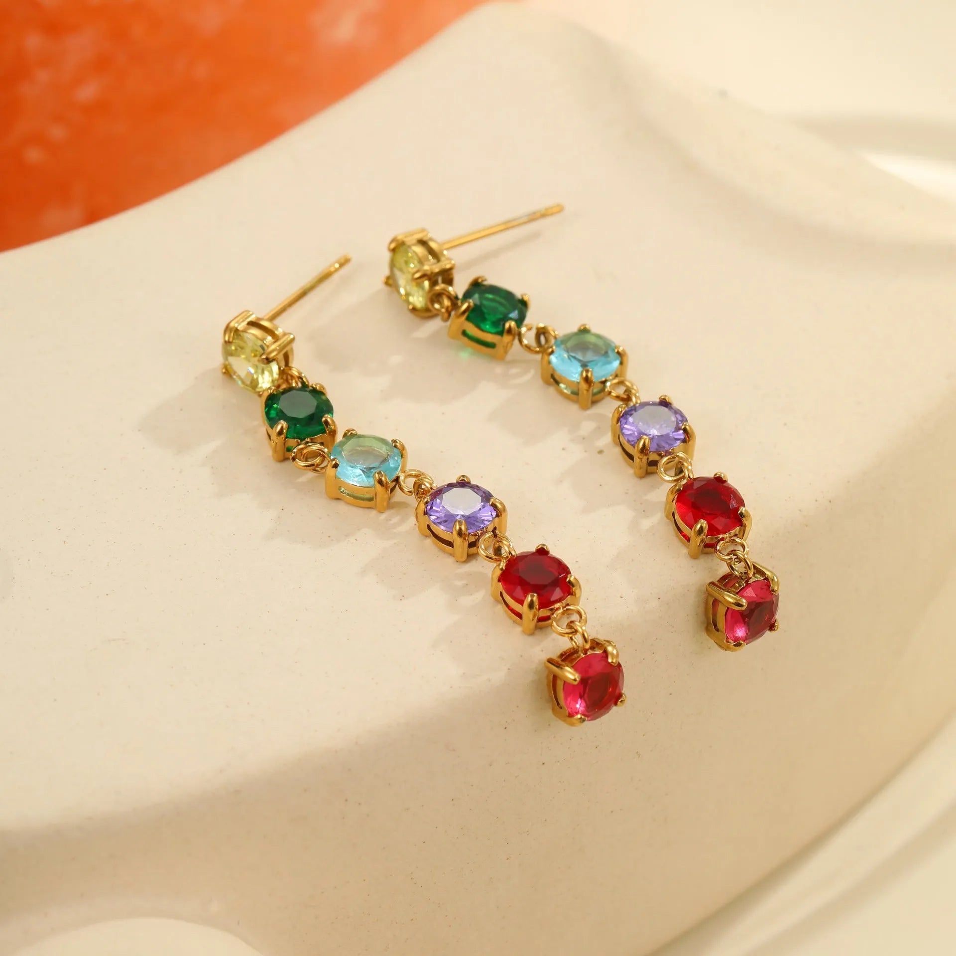 Gold-finish stainless steel earrings with inlaid colour zircon in geometric round and diamond pattern