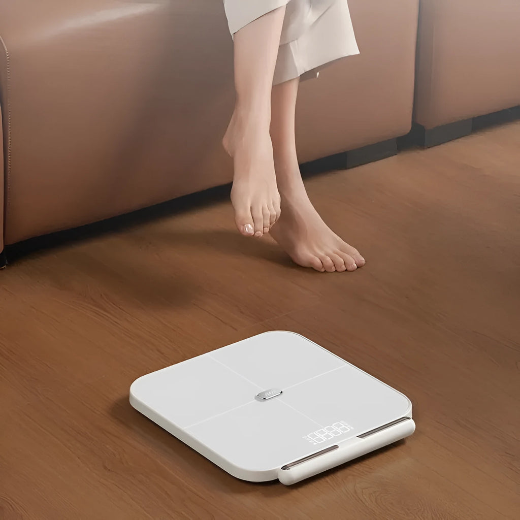 White professional body fat scale with eight electrodes and a large tempered glass platform.