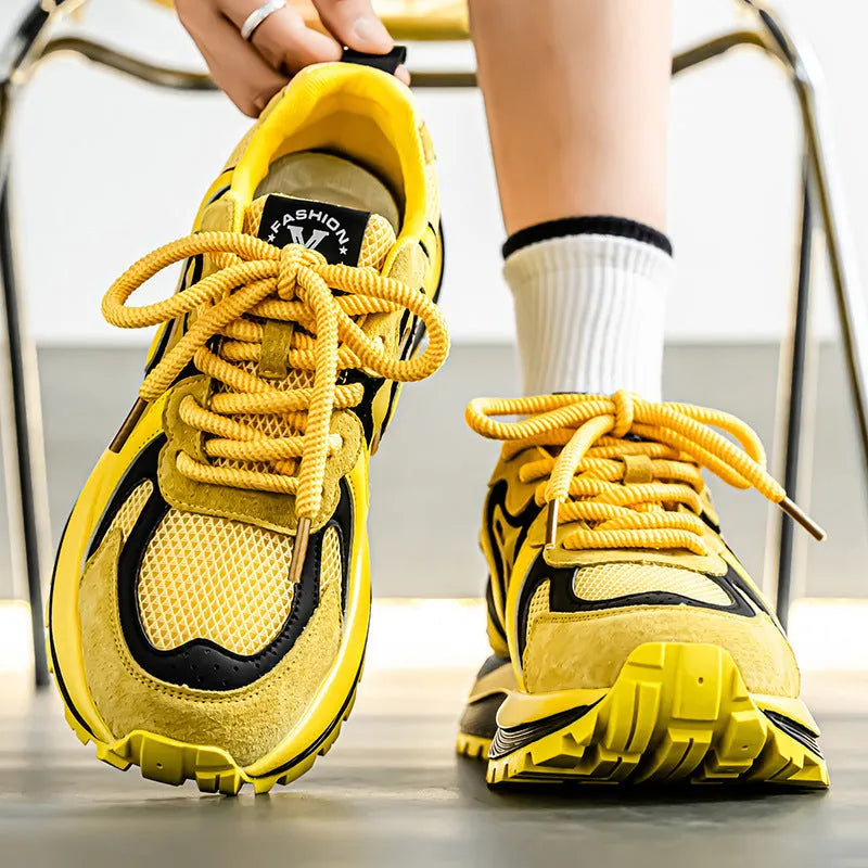 Men's yellow casual sneakers with mesh panels, round toe, and rubber sole displayed from side view