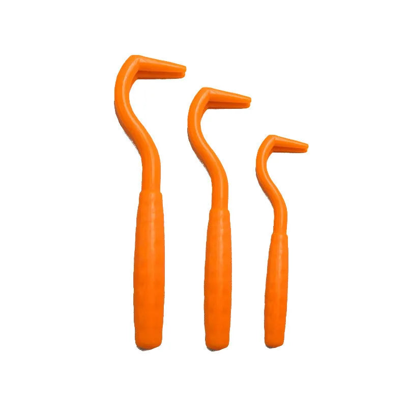 Set of three coloured plastic tick removal hooks for dogs on a white background.