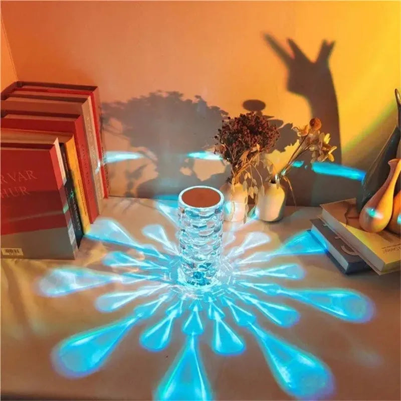 Crystal table lamp rechargeable with teardrop acrylic shade showing droplet shadow effect on a bedside table