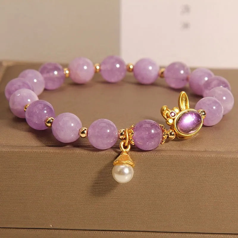 Purplish red jade rabbit hare head charm on a crystal Mori style bracelet.