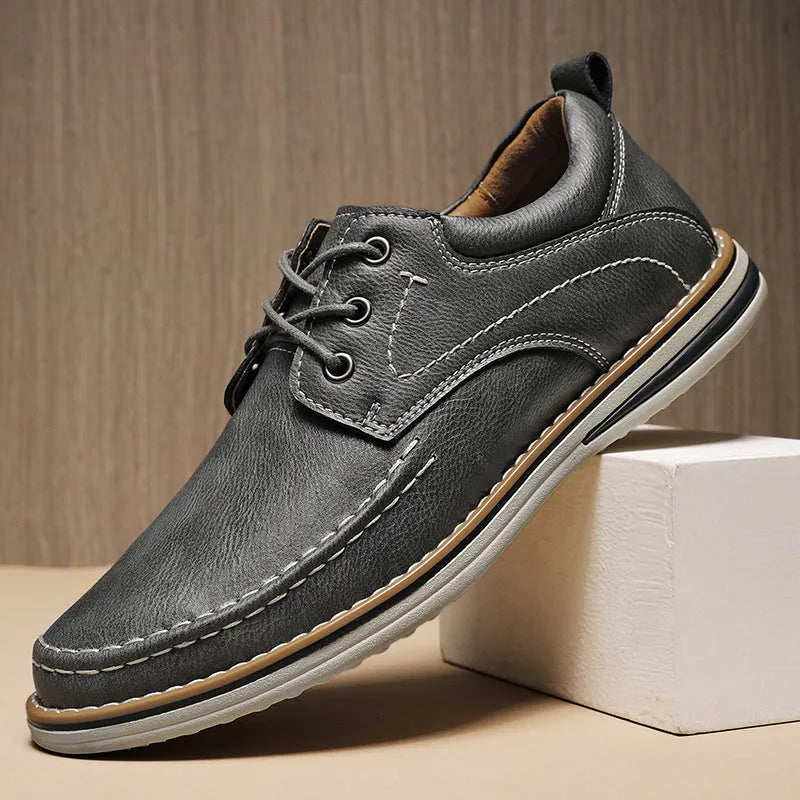 Men's black genuine leather casual lace-up shoes with round toe and low heel on a rubber sole.