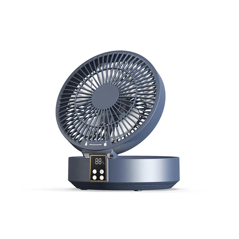 White portable folding electric fan with remote control and warm night light on a desk.