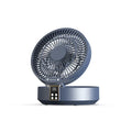White portable folding electric fan with remote control and warm night light on a desk.