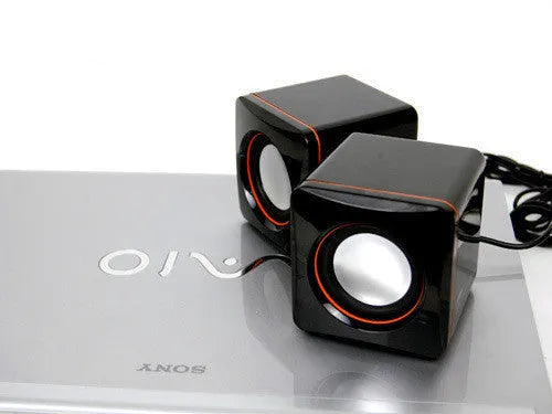 A small black square USB-powered 2.0 speaker for 700B computer systems.