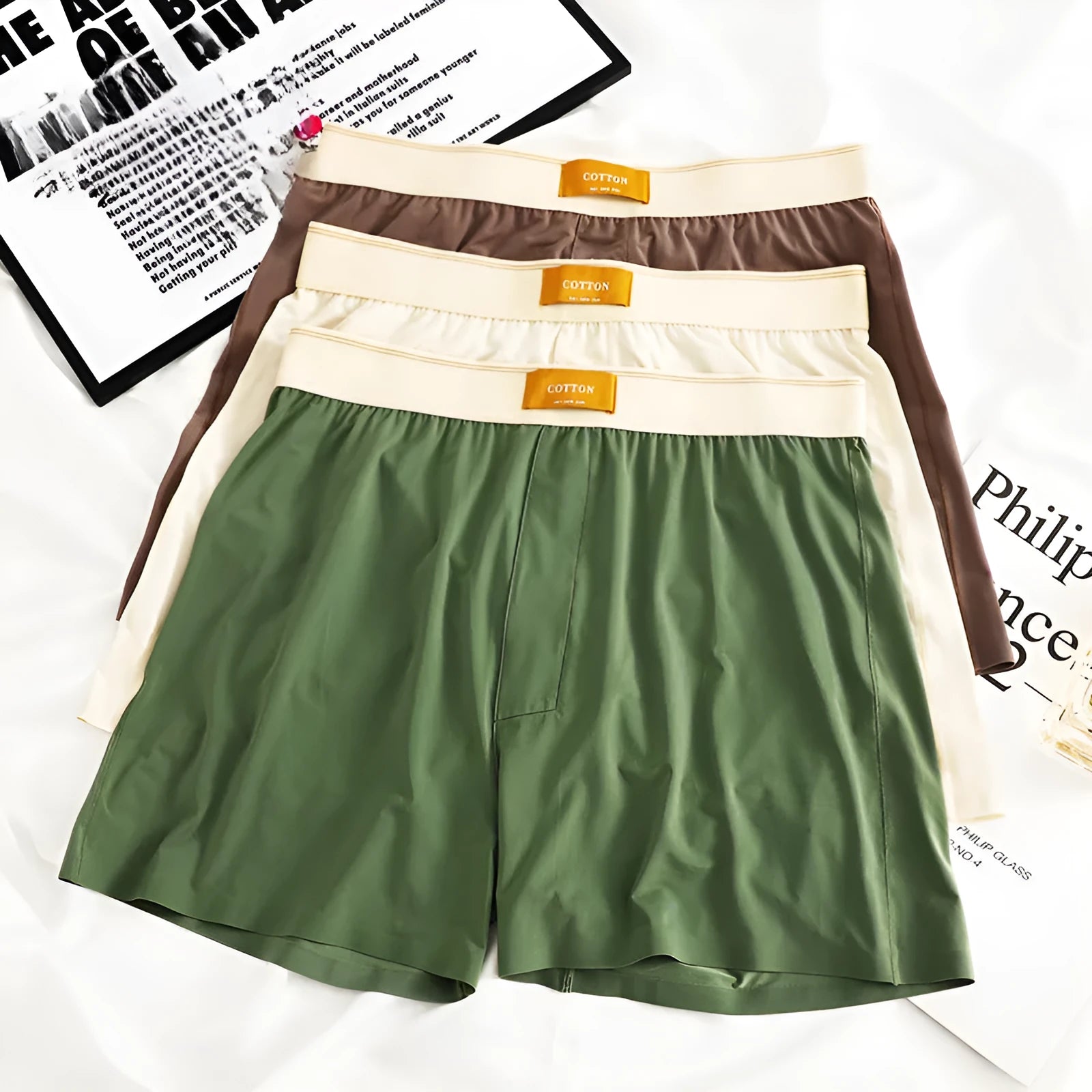 Men's loose fit ice silk underwear in solid colours showing mid-waist design and knitted fabric texture