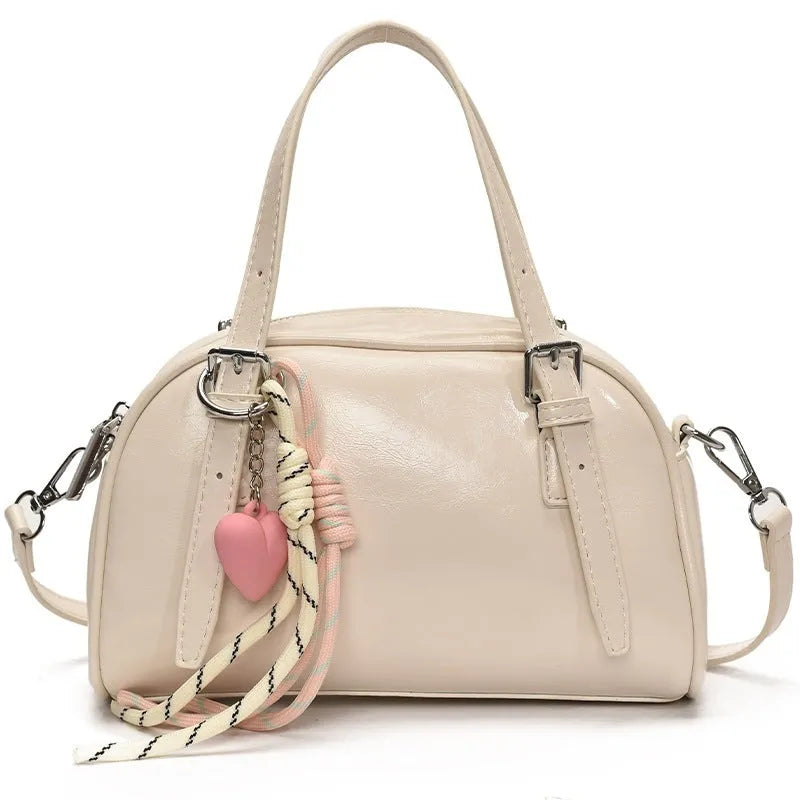Soft black PU leather Korean-style shell-shaped women's shoulder bag with a pendant.