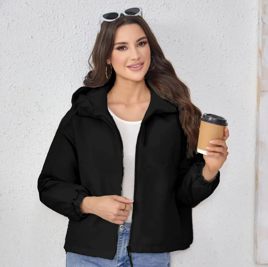 Women's loose fit hooded shell jacket in polyester, shown in grey, black, or purple.