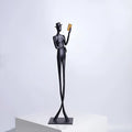 Black aluminium reading woman desktop sculpture with modern geometric design