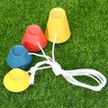 Set of four rubber golf tee ball holders in blue, yellow, and red with four feet each, 2cm height