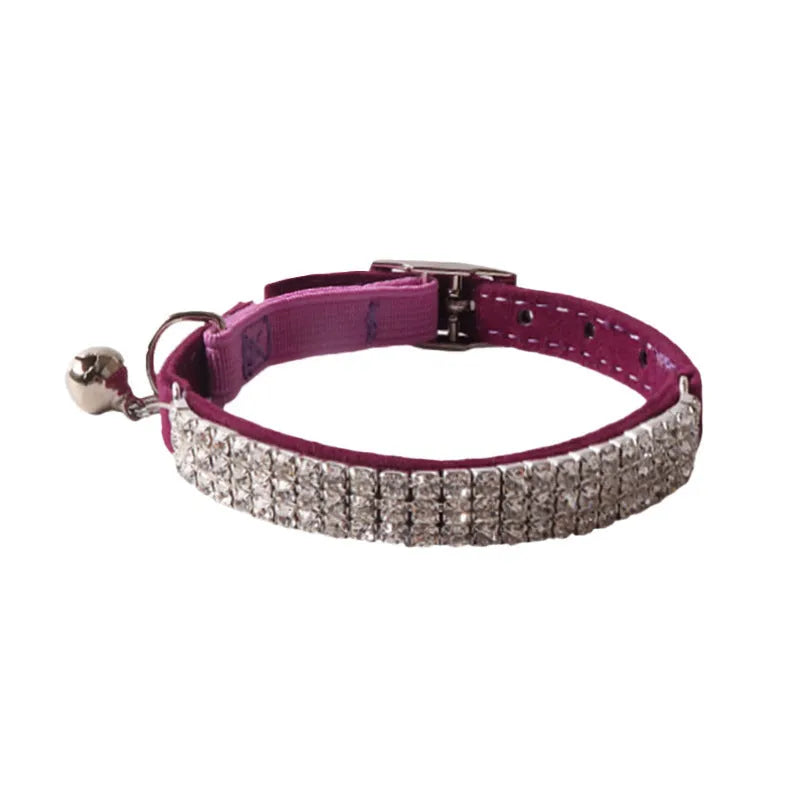 Soft flocked cat collar with elastic buckle in multiple colours on a white background.