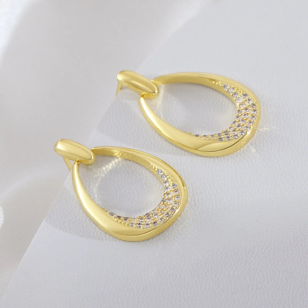 Yellow gold geometric drop earrings with zircon accents measuring 2.6cm x 1.7cm