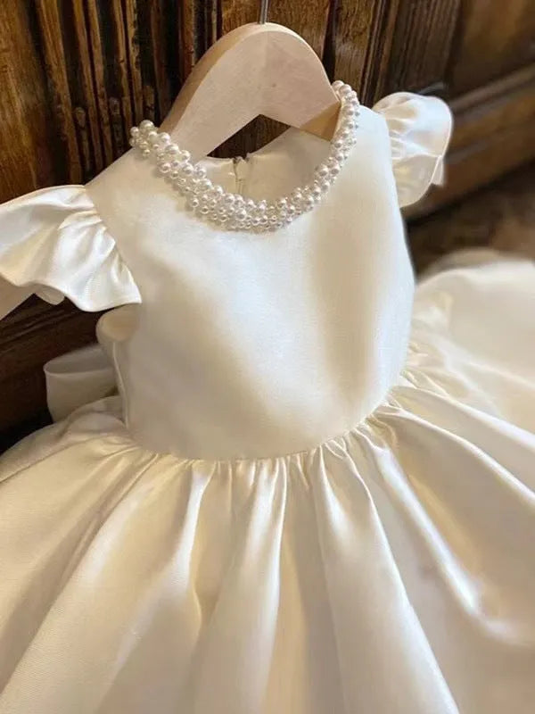 White satin princess dress for girls with puff sleeves, chemical fibre fabric, and flax lining on a white background