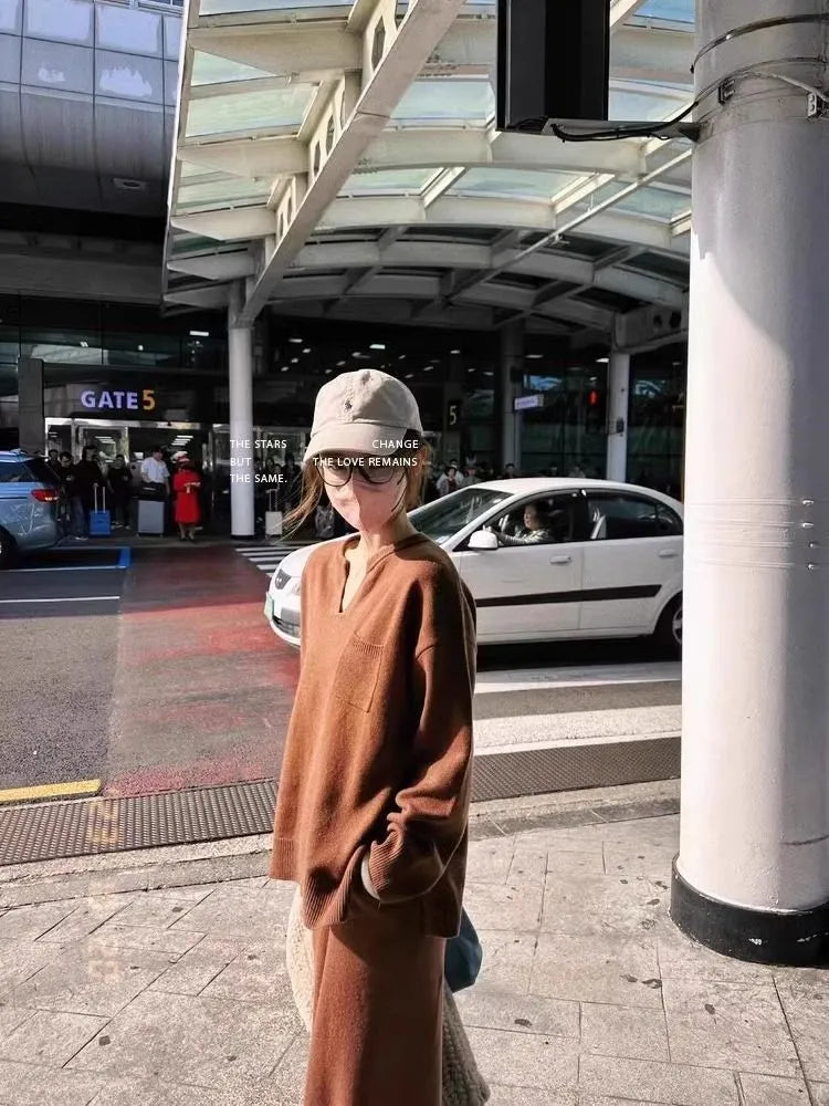 Women's V-neck knitted two-piece suit with wide-leg pants in beige, showing asymmetric pleating on top