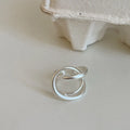 Geometric open ring with 3D interlaced pattern in matte metal finish