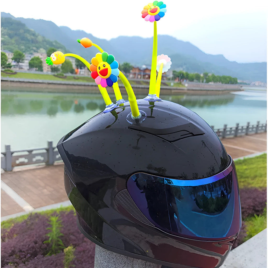 Yellow silicone sunflower decoration with a clear suction cup for helmet attachment.