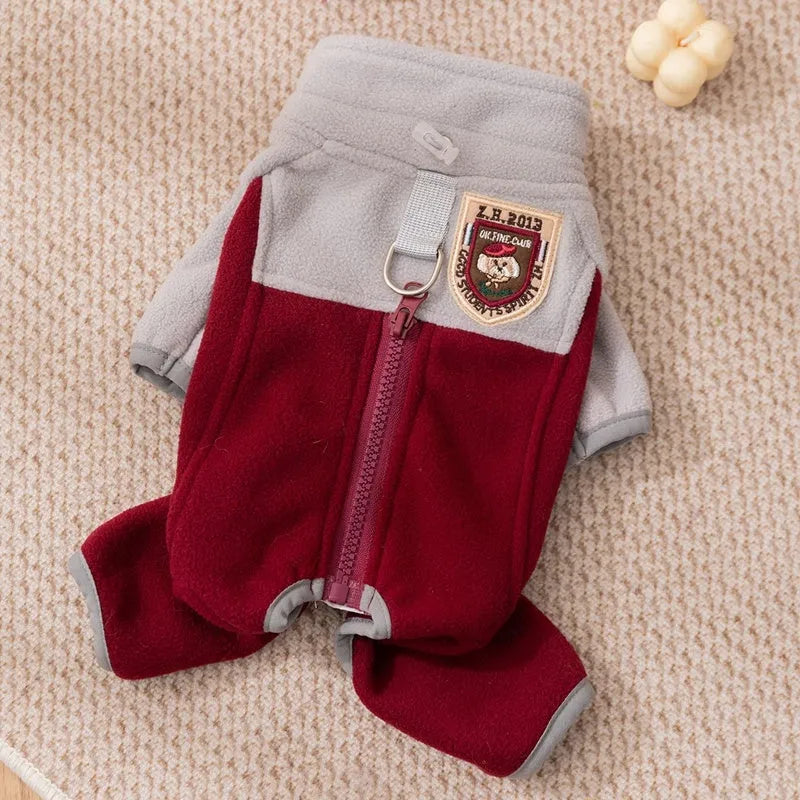Four-legged fleece jacket for cats and small dogs in colour block design with badge patch, showing front zipper and elastic cuffs.