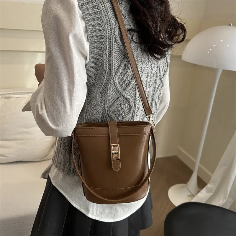 Women's one shoulder crossbody bag bucket shape in PU leather, available in black, brown, khaki, white. Width 19cm height 18.5cm.