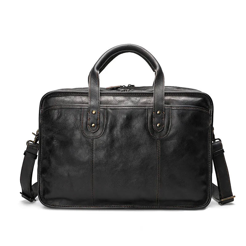 Men's vintage brown leather briefcase open to show internal laptop and camera pockets.