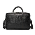 Men's vintage brown leather briefcase open to show internal laptop and camera pockets.