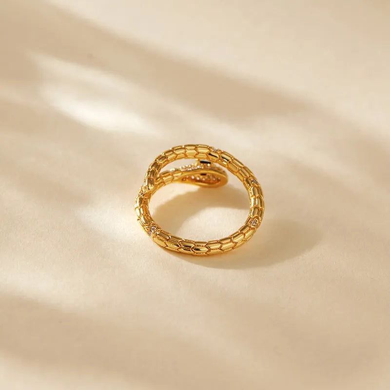 Snake-shaped adjustable copper ring with gold colour plating and diamond surface treatment
