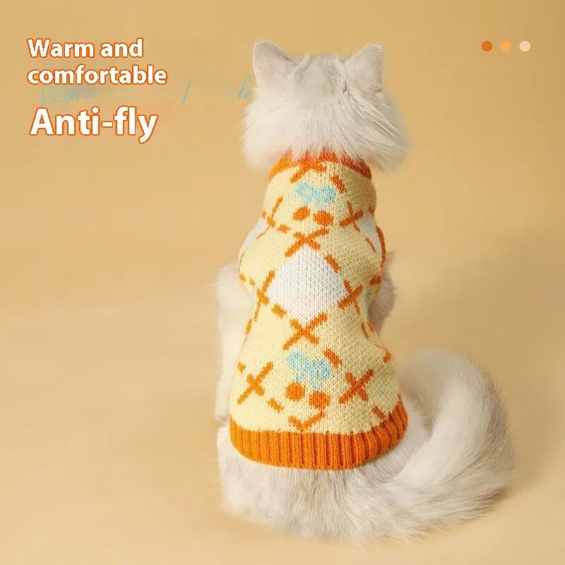 Orange diamond knit cat jumper showing chest measurement points and size labels