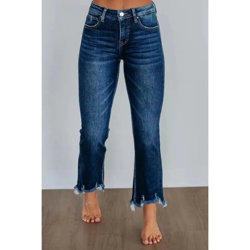 Women's solid colour denim jeans in dark blue showing hand-worn texture and casual fit.