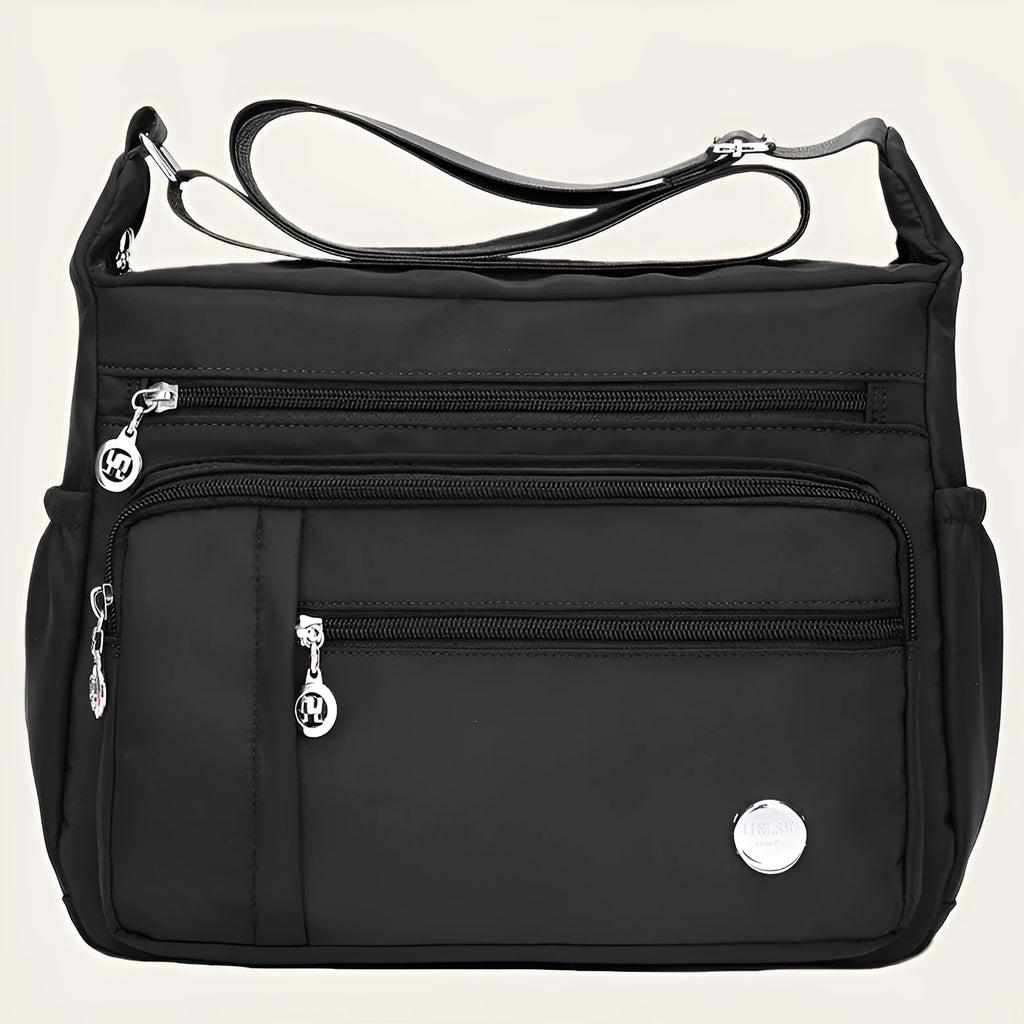 Lightweight nylon women's one shoulder crossbody bag in black with horizontal square shape and visible sewing thread detail