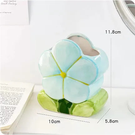 Ceramic pen holder storage box with floral pattern decoration on desktop