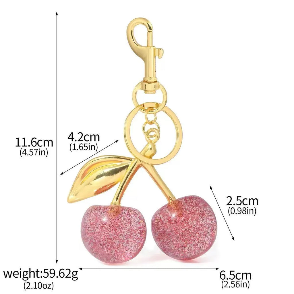 Red zinc alloy 3D cherry keychain pendant with metal loop for keyring attachment.