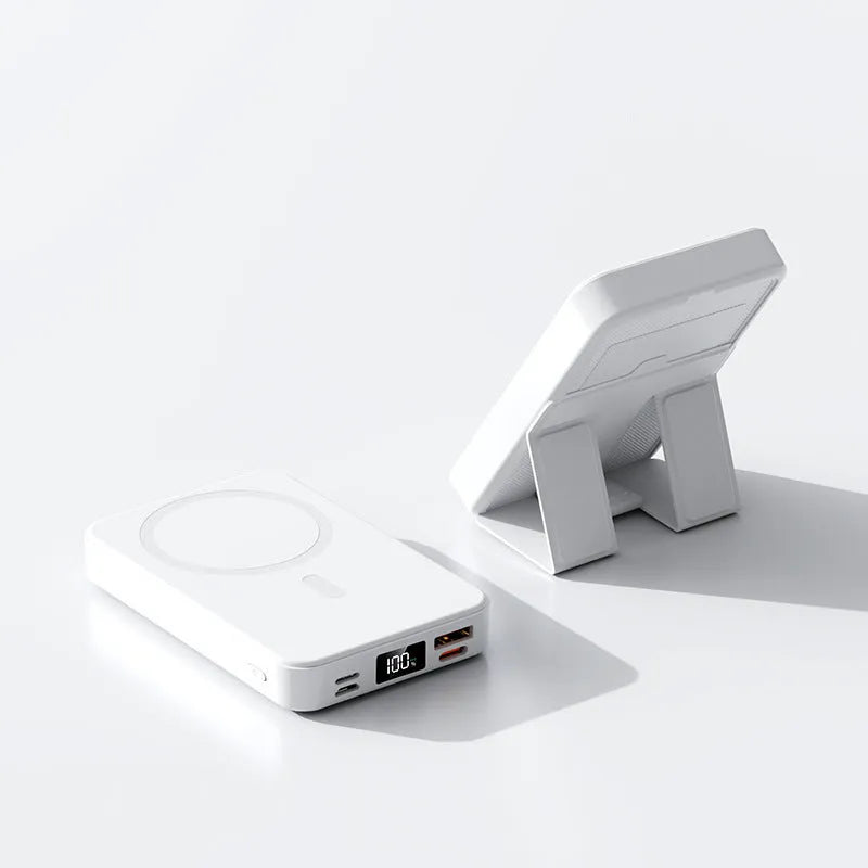 Magnetic wireless power bank with bracket in white, showing 10000mAh capacity and USB port, on a desk