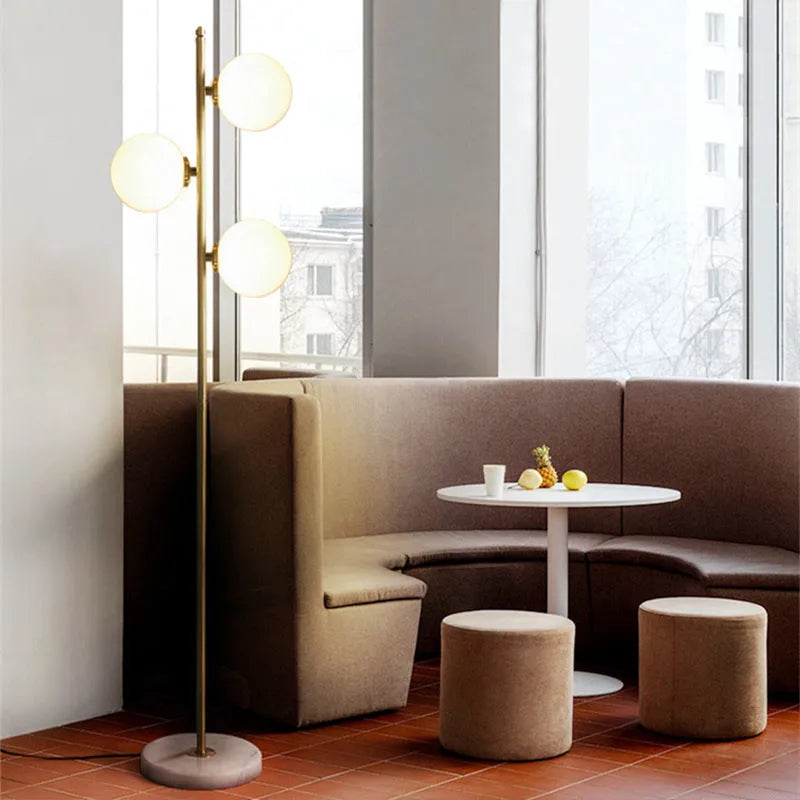 Creative minimalist floor lamp with warm LED light, gold aluminium alloy frame and glass shade