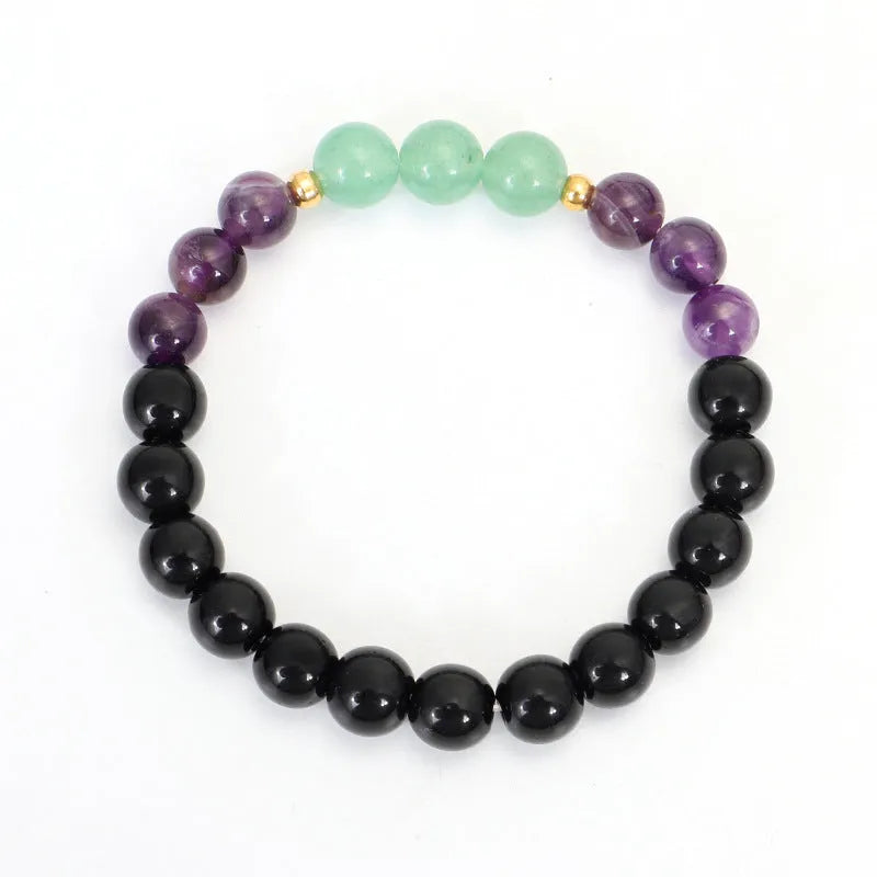 Yoga lotus pendant necklace and bracelet set with stone beads on a white background