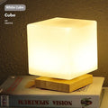 Nordic USB table lamp with geometric white light and solid wood decoration on bedside table