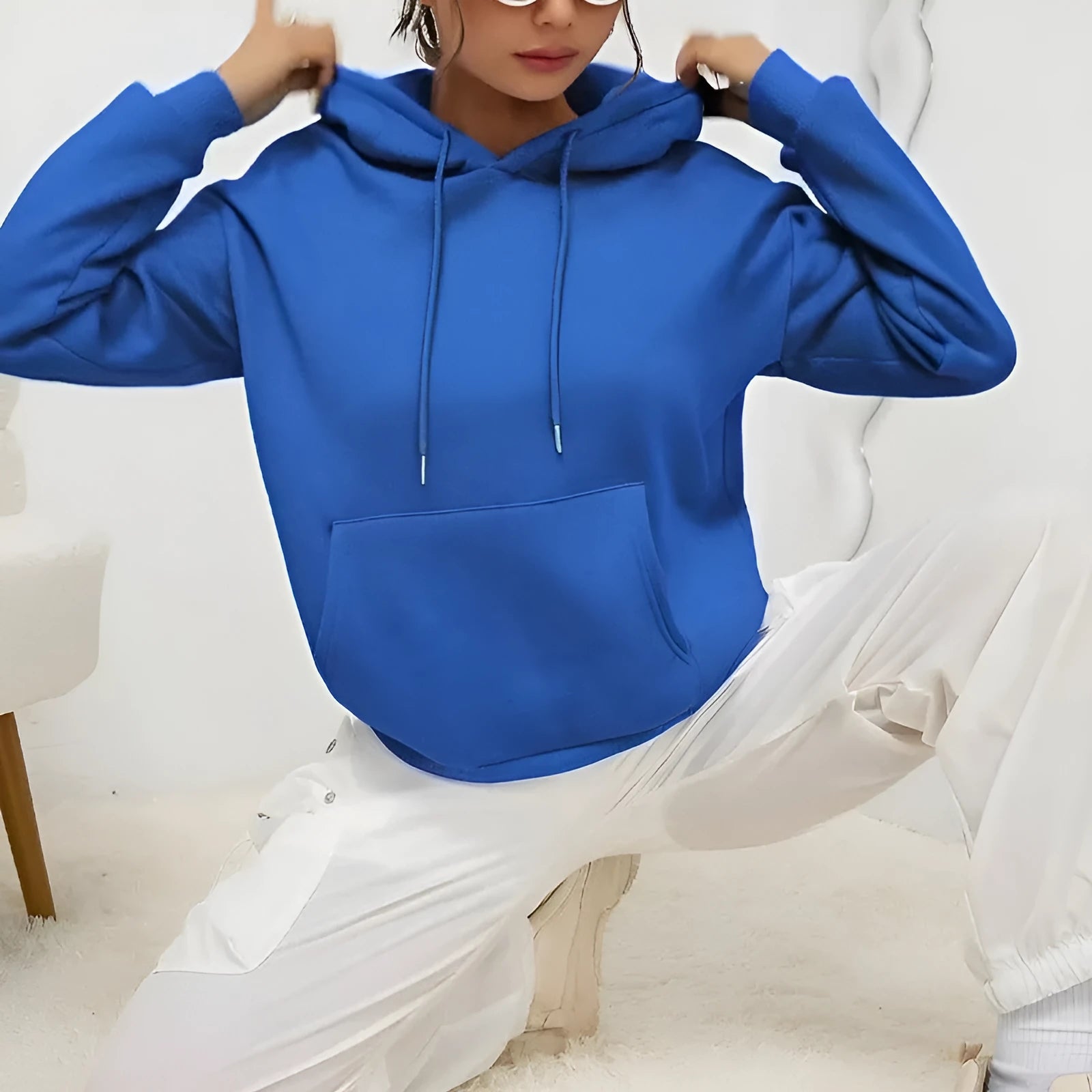Loose fit women's drawstring hoodie in a choice of multiple colours on a hanger.