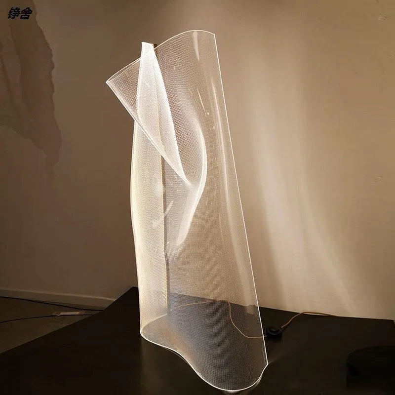 Irregular acrylic ribbon table lamp with warm light on a living room side table