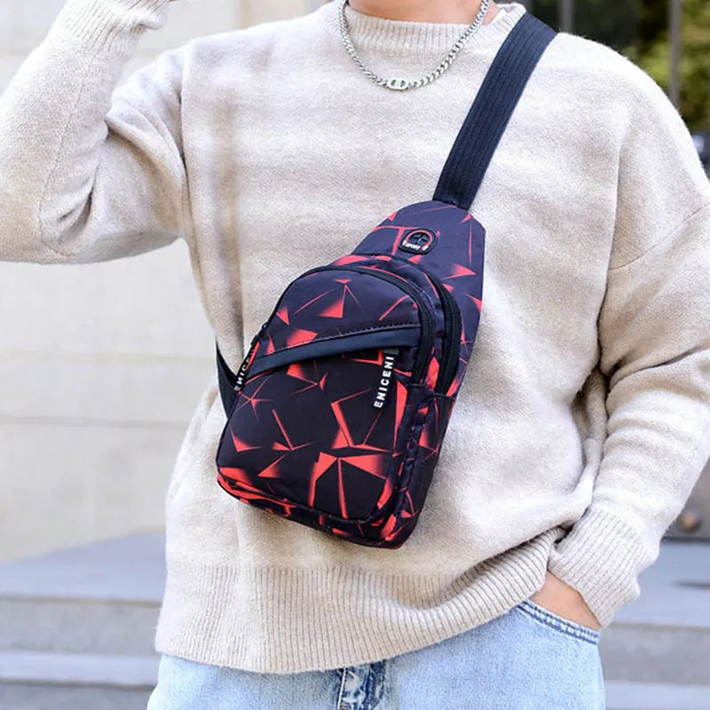 Men's blue print sling chest crossbody bag showing earphone hole and zipper pocket.