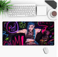 Anime style gaming mouse pad desk mat with non-slip rubber base on a desk.