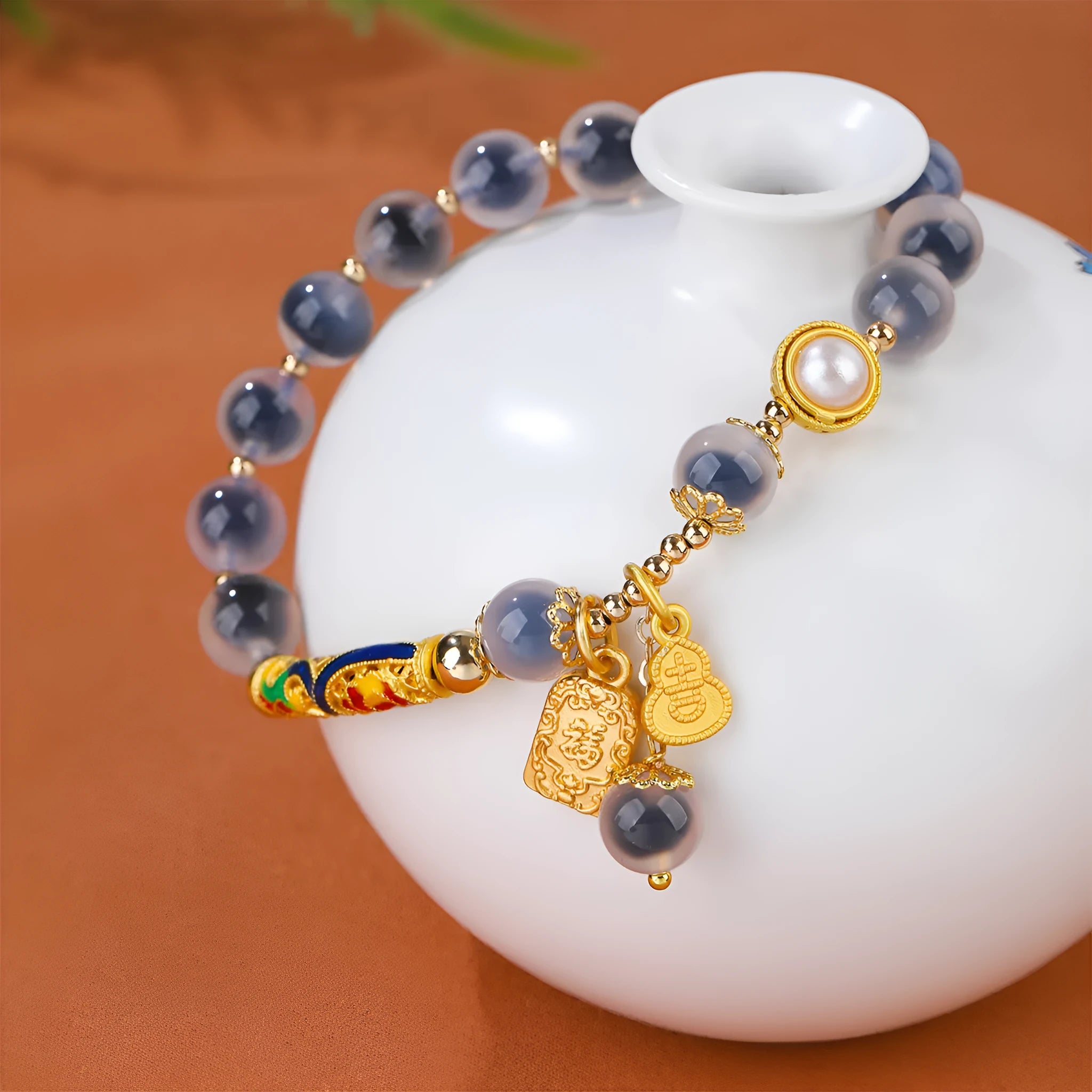 Close-up of a women's sugar heart agate beaded bracelet with an adjustable knot closure on a wrist