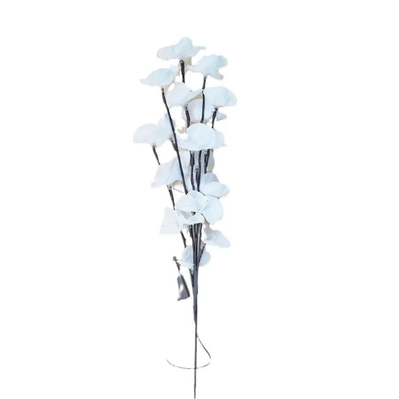Pink phalaenopsis orchid branch decorative light with 20 LEDs, standing 65cm tall on a table.