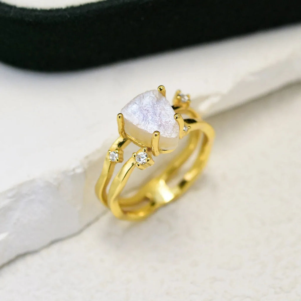 S925 silver geometric ring with irregular triangle shape and moonstone on a model's hand.