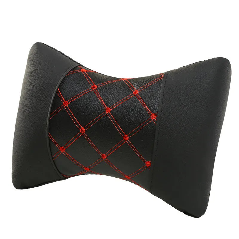 Pair of black diamond-quilted car headrest pillows with blue stitching for neck support.